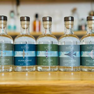 A row of 5 bottles of the Aviation Collection with heritage aircraft on the labels